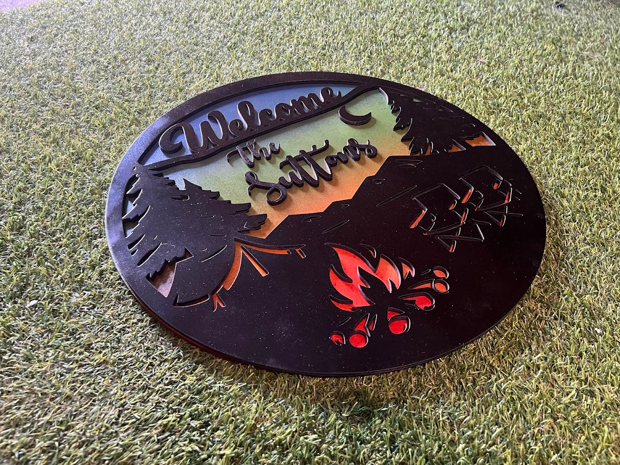 Decorative metal sign with cut-out designs on a grassy background