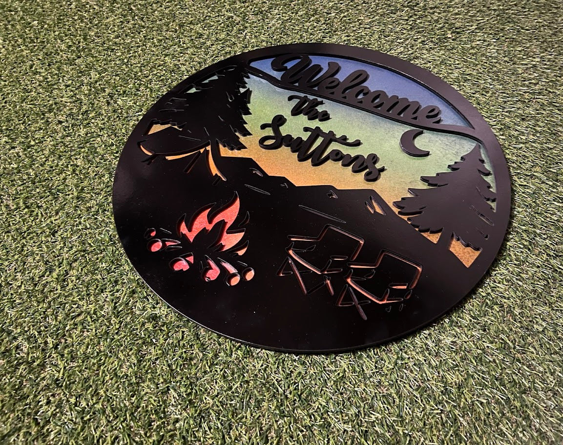 Decorative metal sign with nature-themed design and 'Welcome to the Scatter' text on grass.